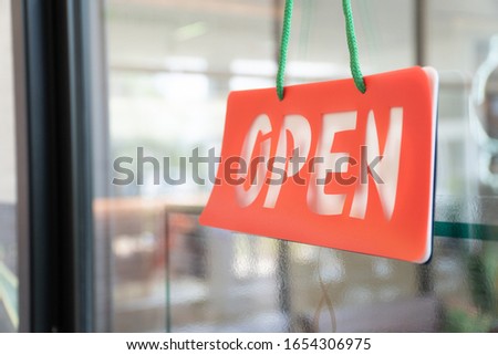 Open sign door in the store shop.