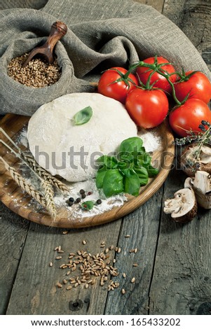 Pizza dough on old wooden table
