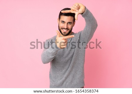 Caucasian handsome man over isolated background focusing face. Framing symbol