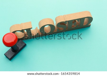"closed" wooden sin board with blue background. restaurant sign board. closed sign with logo stamped. closed deal concept photo.