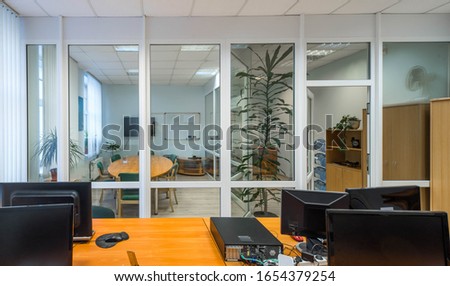 Meeting room behind the glass wall. Corporate culture. Modern interior of office. Workplace.