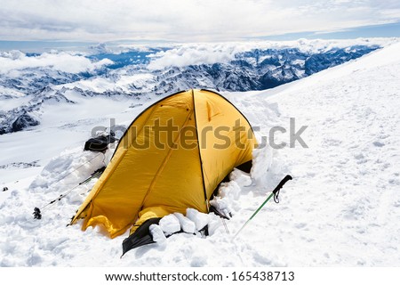 Expedition camping in tent on Mount Elbrus trail to the top, Mountain landscape in autumn or winter in Caucasus Mountains i Russia and Georgia, view from Elbrus(5642m) slopes on Pastuchov Rocks 4700m
