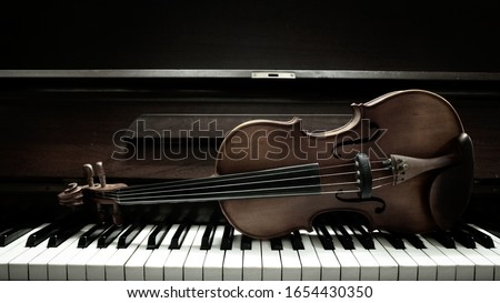 violin on piano keys top.