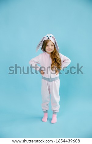 baby girl in Bunny costume on blue background