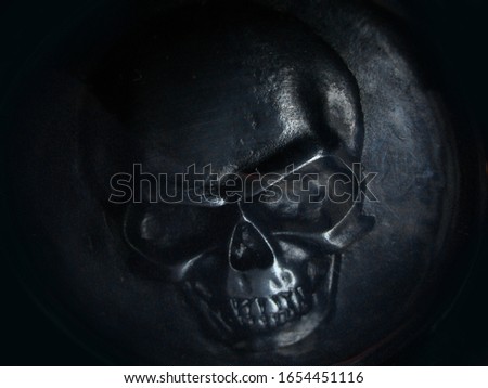 Metallic skull pattern for design. Dark background. Death abstract art. Sorcerer symbol background. Fear copy space.
