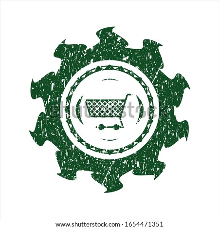 Green shopping cart icon inside distress rubber stamp