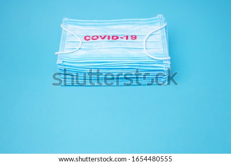 COVID-19. Facial masks on the pile. Epidemic background. Shortage of facial masks at drug store. Quarantine background. Medical masks for protection. Dangerous virus. Facial masks one on one Royalty-Free Stock Photo #1654480555