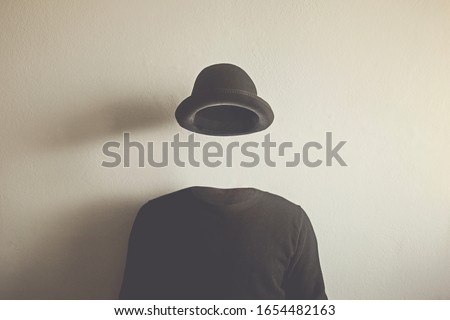 invisible man wearing black bowler, surreal concept of absence of identity Royalty-Free Stock Photo #1654482163