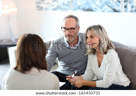 Senior couple meeting financial adviser for investment Royalty-Free Stock Photo #165450731