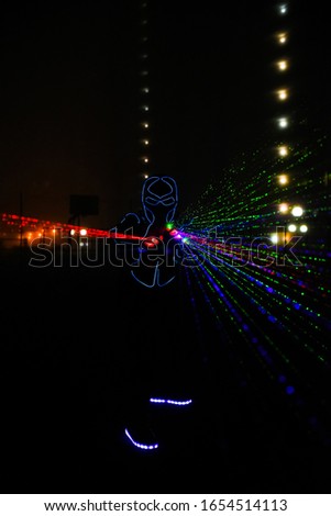 multi-colored laser beams. man laserboy. laser lines in the dark