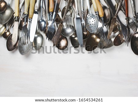 Old vintage spoons on white wooden background. Top view, copy space