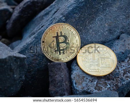 golden bitcoins on the stones. yellow btc on the rocks. gold coin beautiful. Stock photo. Crypto mining currency, miner