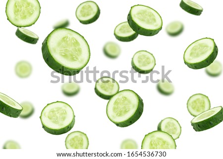 Falling cucumber slice isolated on white background, selective focus Royalty-Free Stock Photo #1654536730