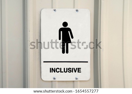 Gender neutral restroom sign that says, INCLUSIVE. 