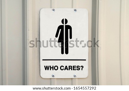 Gender neutral restroom sign that says, WHO CARES? 