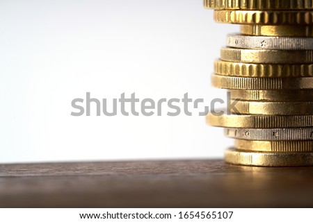 Euro coins stacked on each other in different positions Royalty-Free Stock Photo #1654565107