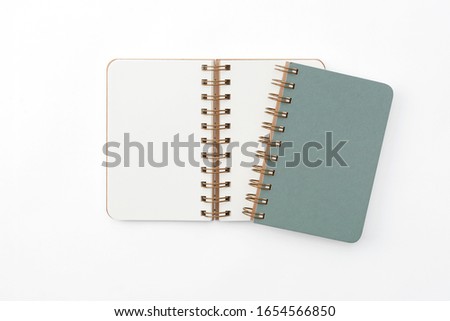 Top view of closed spiral blank recycled paper cover notebook on white background additional clipping path.
