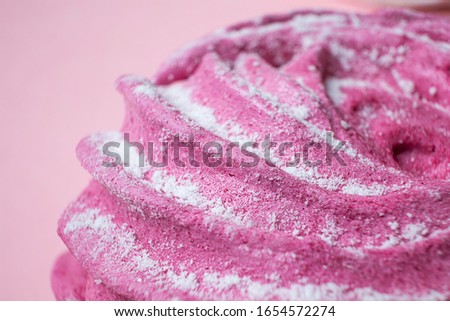 Fresh berry marshmallows sprinkled with powdered sugar, closeup. Detailed macro photo. The concept of home cooking, sweets. Minimalism, copyspace.
