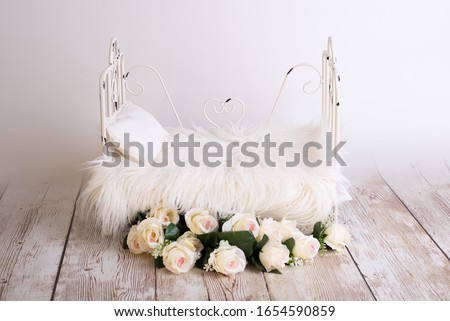 white wooden log bed for newborns Royalty-Free Stock Photo #1654590859