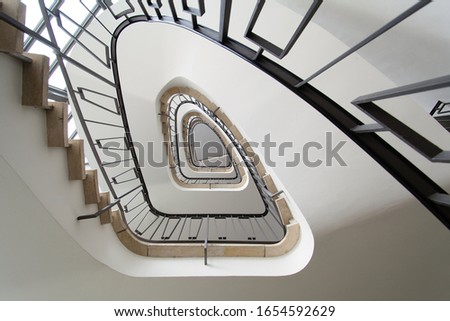 Spiral white staircase from ca 1950. Taken from below with visible black stair railing