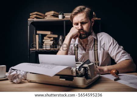 A Thoughtful Writer Propping His Chin Up Royalty-Free Stock Photo #1654595236