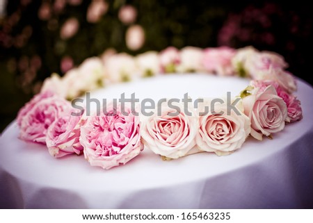 Roses and peonies bridal wreath on white cloth