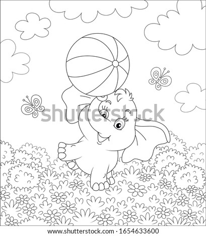Little elephant playing with a big striped ball on grass among flowers and flittering butterflies on a summer field on a sunny warm day, black and white vector cartoon illustration for a coloring book