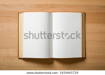 Opened book with white sheets Royalty-Free Stock Photo #1654665724