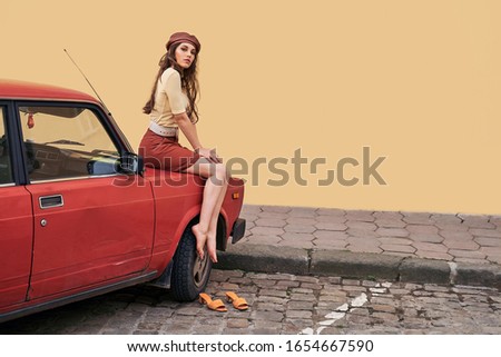 Young beautiful girl dressed in retro vintage style enjoying the summertime lifestyle of old european city Royalty-Free Stock Photo #1654667590