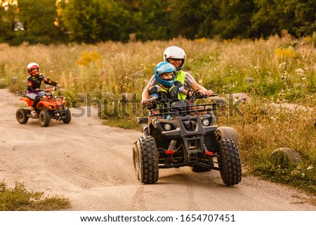 little boy with instructor on a quad bike