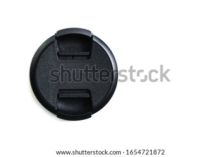 Black cover for digital camera lens on a white background. Isolate, copyspace