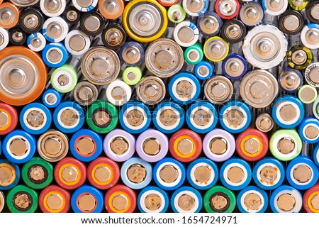Close up of colorful spent discharged batteries of different sizes and formats. Used rechargeable Nickel Metal Hydride (Ni-MH), Nickel-Cadmium(Ni-Cd) batteries with corrosion and rust. Recycle concept Royalty-Free Stock Photo #1654724971
