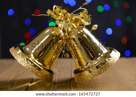 Christmas bells on table on bright background