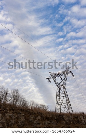 Power Lines on the hillside, under a blanket of cirrocumulus clouds divided by a wispy line of clouds