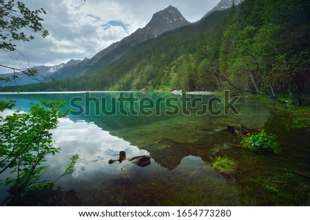View of the quiet water of Lake Antholz in South Tirol, Italy