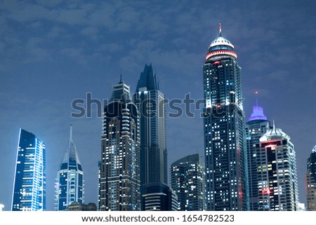 high buildings at night under blue sky