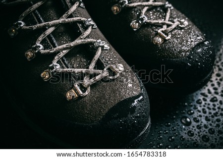 hiking mountain shoes, waterproof, with splashes of water Royalty-Free Stock Photo #1654783318