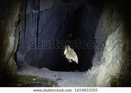 Big icicle in dark cave Austria