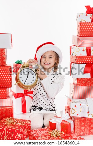 Santa hat Christmas girls holding christmas gifts smiling happy and excited. Cute beautiful santa children on red background.