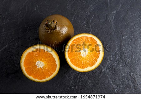 Navel Chocolate oranges is a new variety of oranges. The uniquely colored fruits can be found in European markets during the winter months. Closeup. Copy space. Royalty-Free Stock Photo #1654871974