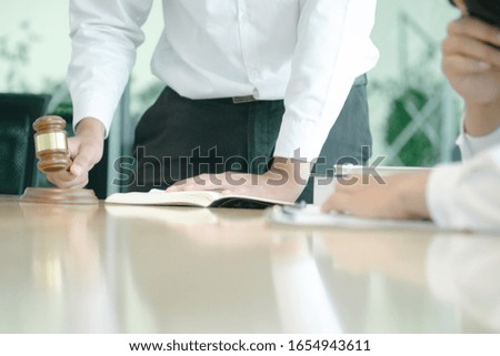smart lawyer holding stamp for submit documents  with advice in the office before considering the judgment, lawyer concept
