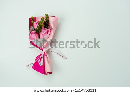 Table top view aerial image of decorations for international women's day or mother's day holiday concept background.Flat lay sign of season the  flower and heart shape paper on pink paper.copy space.