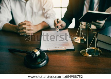 Lawyer explained to the client about the legal issues that must be taken in court in the office. Royalty-Free Stock Photo #1654988752