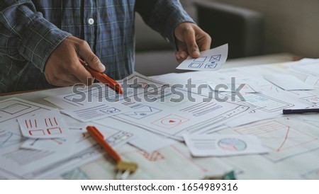 Designers man drawing (UX) (UI) Graphic designer creative sketch planning application process development prototype for responsive web desig