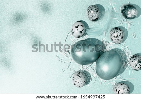 Decorated eggs on blue background. Easter composition. Flat lay, top view, copy space