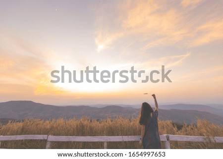 Beautiful girl on the lake,enjoying sunset on peak mountain. Tourist traveler on background valley landscape view mockup. Hiker looking sunlight,The view from the back