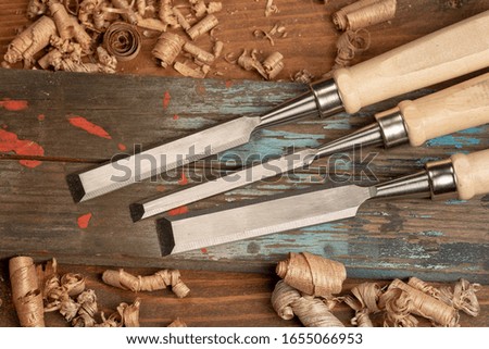 Chisel and wooden mallet with wood shavings. Carpenter cabinet maker hand tools on the workbench.