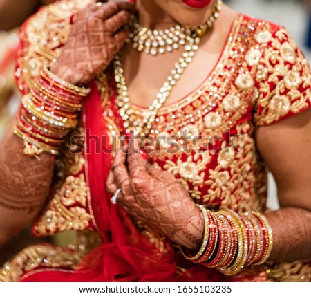 Pakistani Indian Bridal wearing red lehnga sari and holding purse Royalty-Free Stock Photo #1655103235