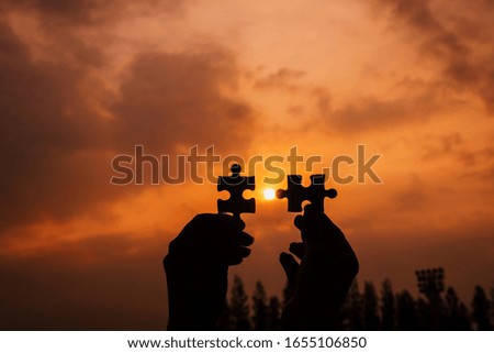 Business success and strategy solutions concept,Hands woman connect couple puzzle piece together with sunlight background