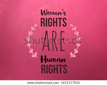 Women’s rights are human rights word on pink paper texture background